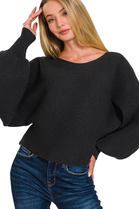 Front view of boat neck balloon sleeve sweater with arms extended, showing dramatic batwing sleeve silhouette and ribbed texture