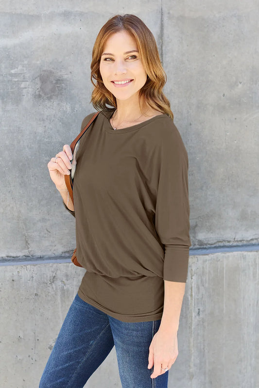 Side view of Basic Bae full size round neck batwing sleeve top highlighting loose fit and draping batwing sleeves