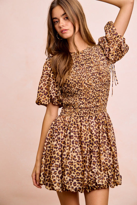 Front view of BiBi Leopard Bow Tie Dress highlighting attachable puff sleeves and chic bow tie feature