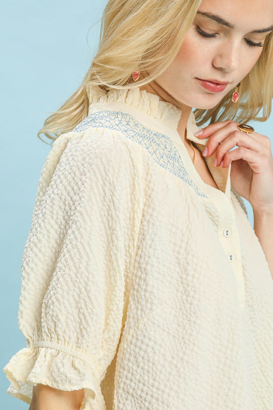 Side view of flowy Henley blouse with elbow-length ruffle cuffs showing relaxed silhouette and textured fabric