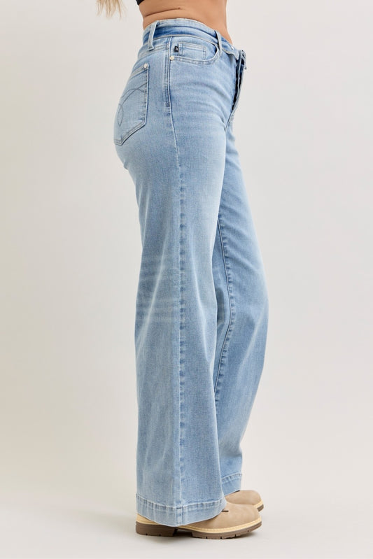 Side view of Judy Blue wide leg jeans showing mid rise fit, fold-over waistband detail, and relaxed wide leg silhouette.