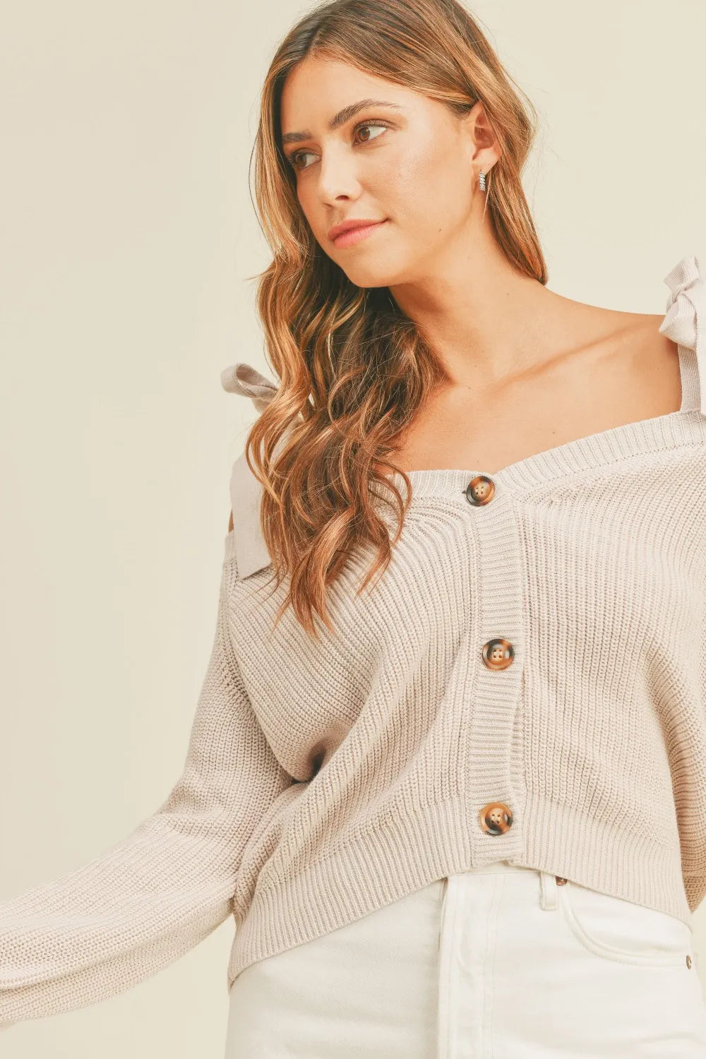 Side view of MABLE Off Shoulder Self Tie Strap Button Down Sweater highlighting off-shoulder design and relaxed fit