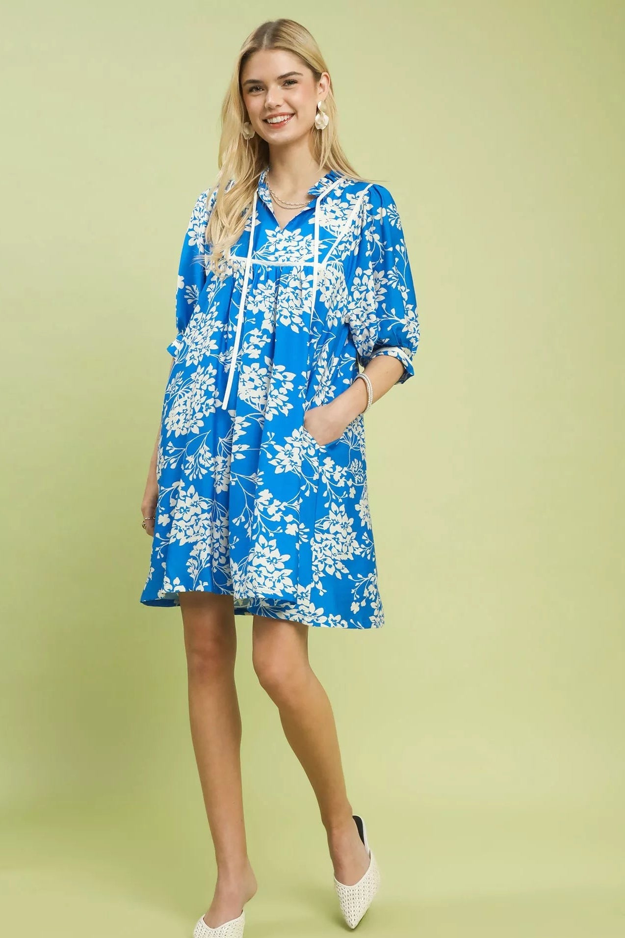 Close-up front view of Umgee floral babydoll dress highlighting neckline, sleeves and pockets