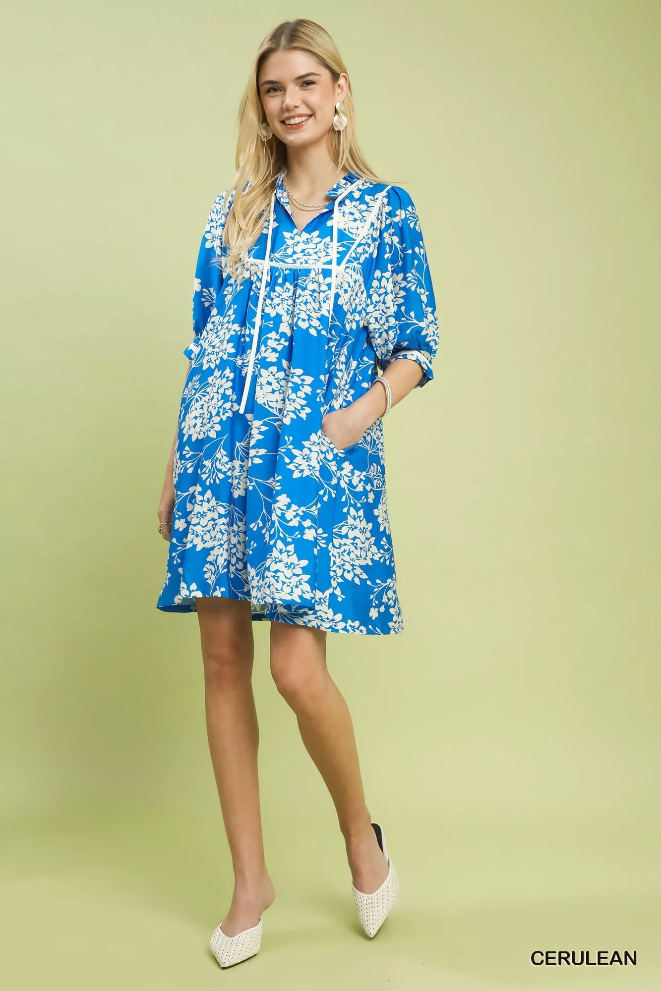 Close-up front view of Umgee floral babydoll dress highlighting neckline, sleeves and pockets