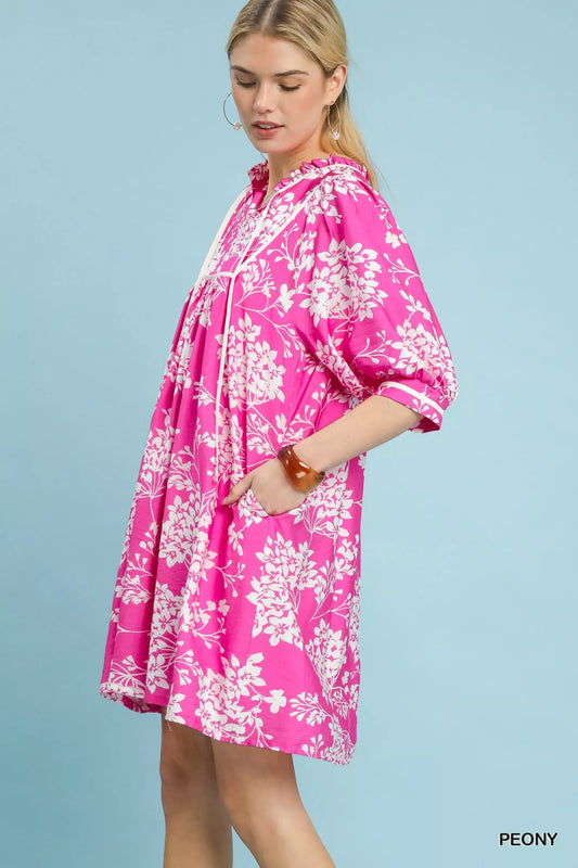 Side view of Umgee floral babydoll dress with pockets showing relaxed silhouette and drape