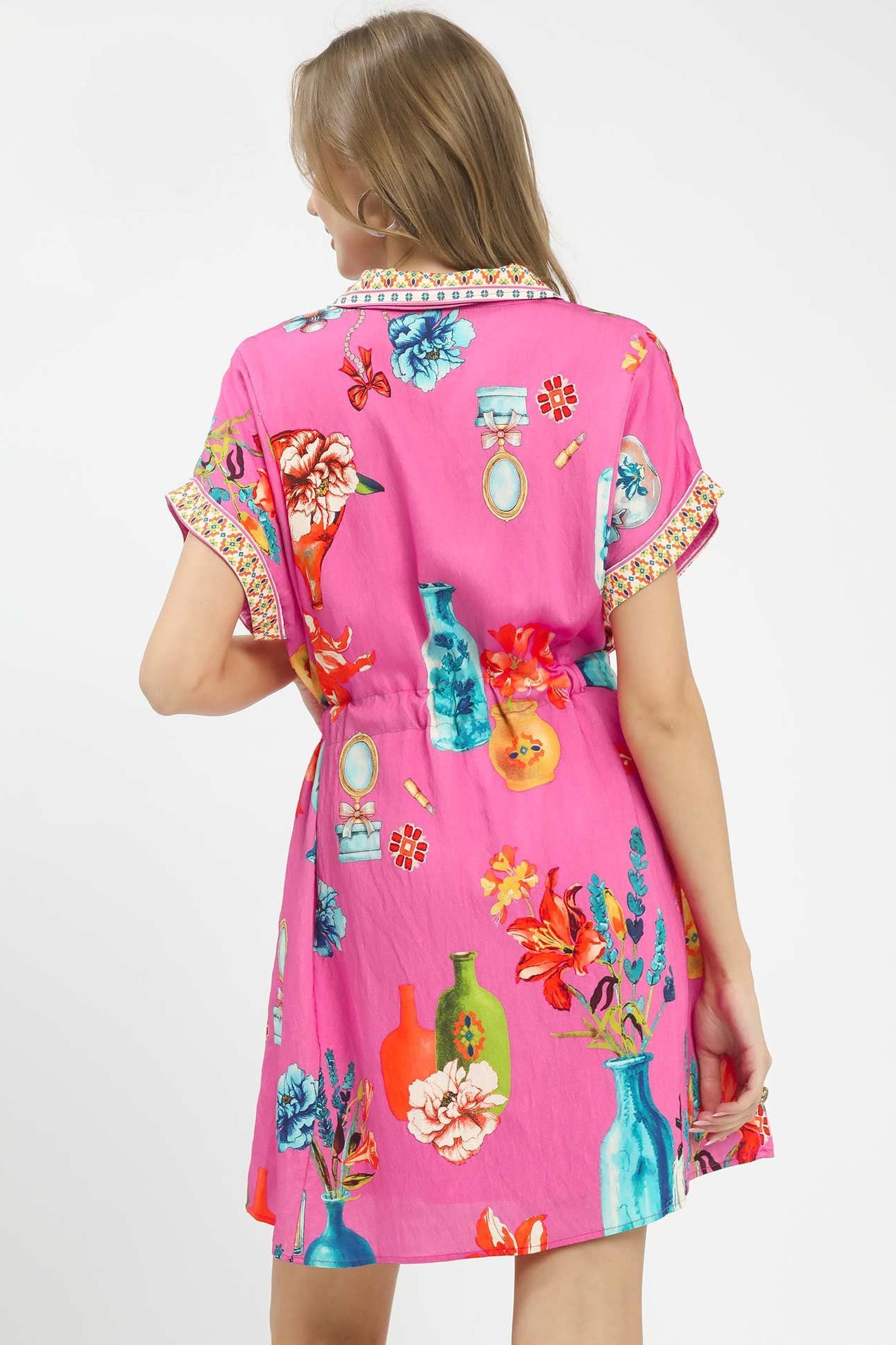 Back view of Umgee floral print mini dress with belt showing clean cut, flattering fit, and trendy boutique style.