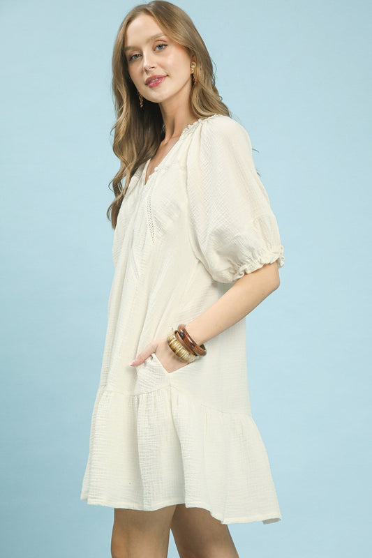 Side view of Umgee cotton gauze tiered mini dress showing lightweight fabric drape, tiered ruffle layers, and mini hem length from the side.