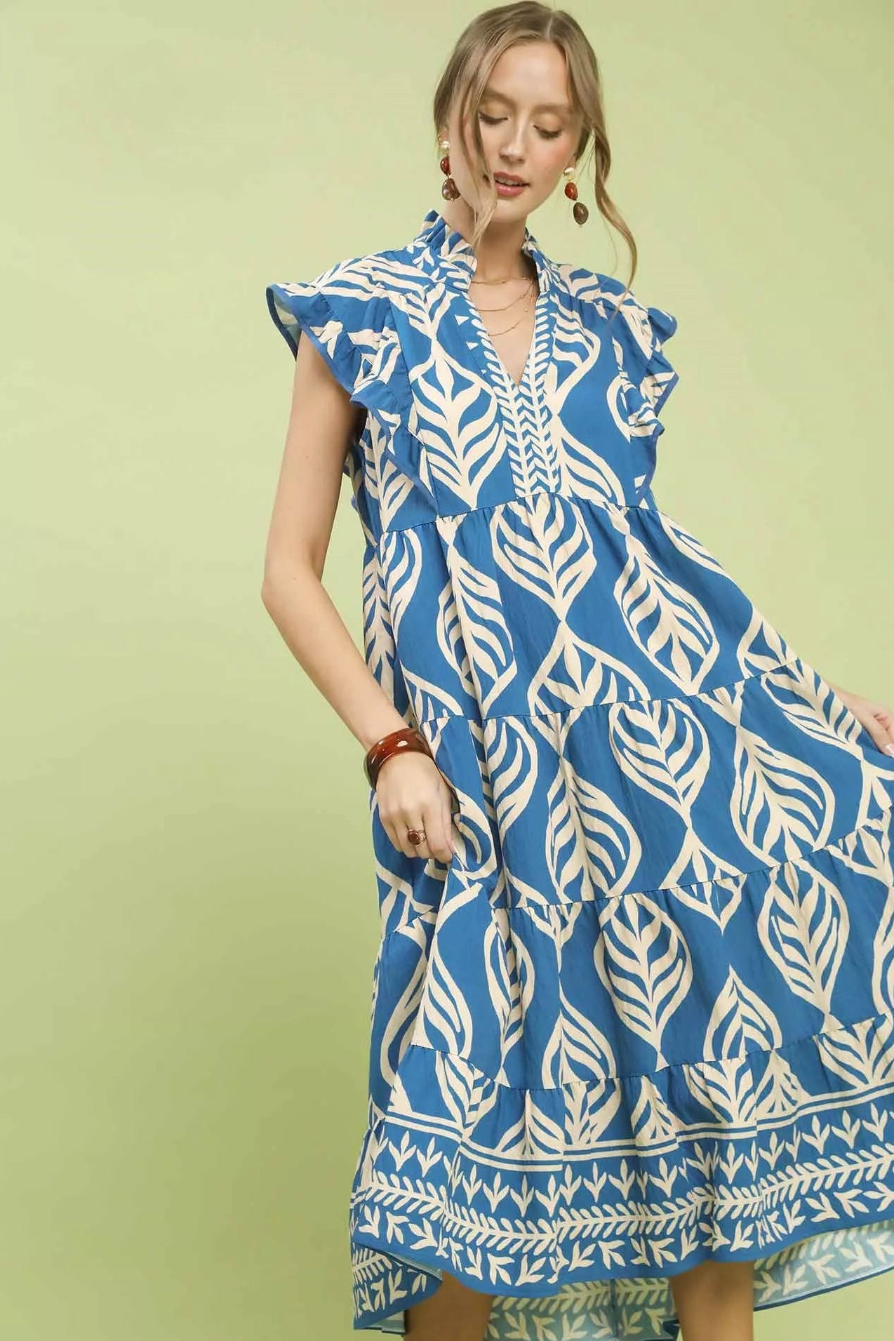 Close-up front view of Umgee Leaf Print Tiered Midi Dress highlighting leaf print, pockets, and flattering midi silhouette.