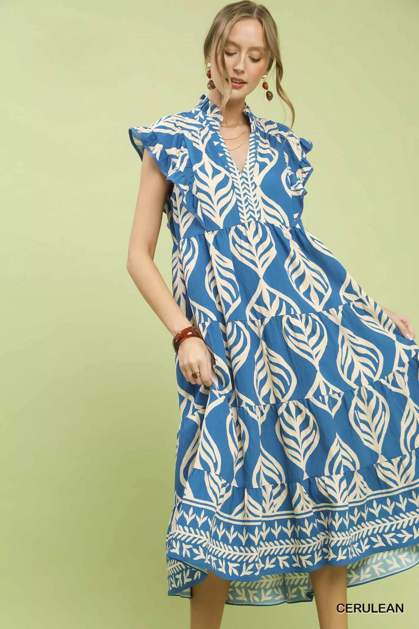 Close-up front view of Umgee Leaf Print Tiered Midi Dress highlighting leaf print, pockets, and flattering midi silhouette.