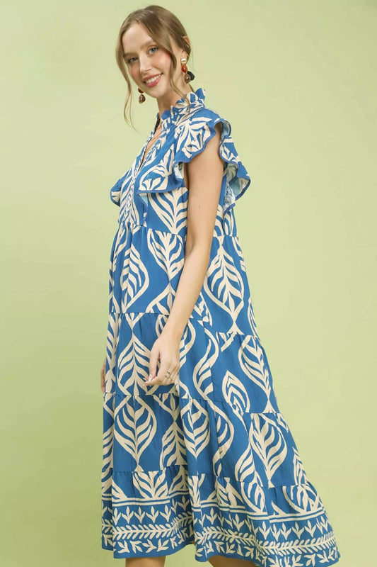 Side view of Umgee Leaf Print Tiered Midi Dress with Pockets highlighting pocket detail and movement of tiered fabric.