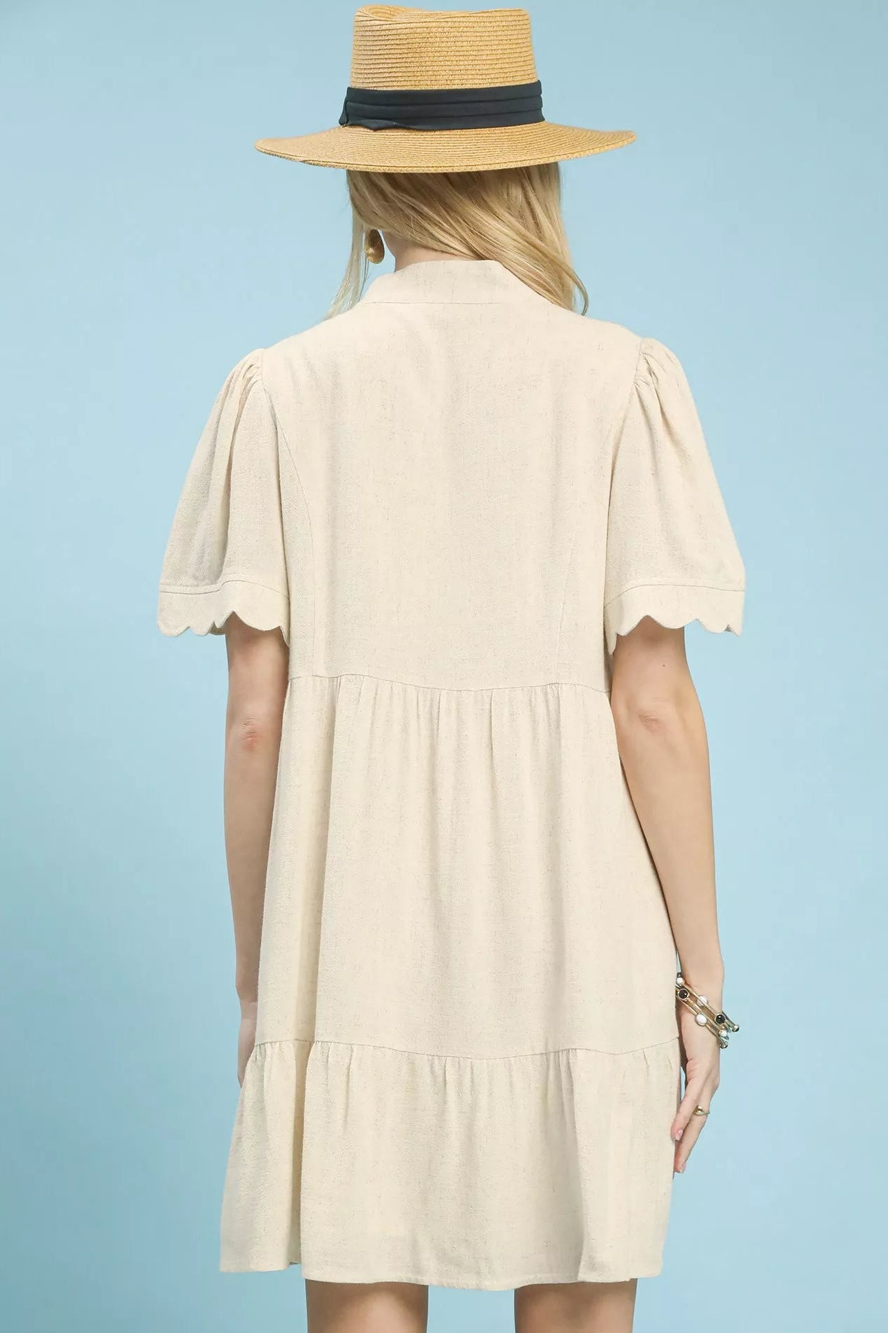 Back view of Umgee linen tiered babydoll dress with scalloped sleeves showing tiered design