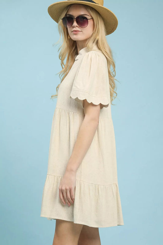 Side view of Umgee linen tiered babydoll dress with scalloped sleeves showing airy silhouette