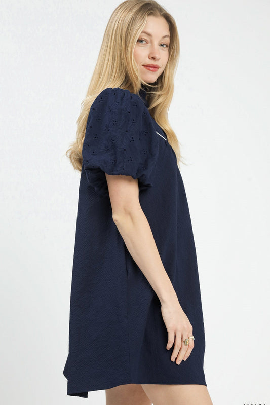 Side view of Umgee babydoll dress showing flowy silhouette, puff sleeve shape, and mini length hemline.
