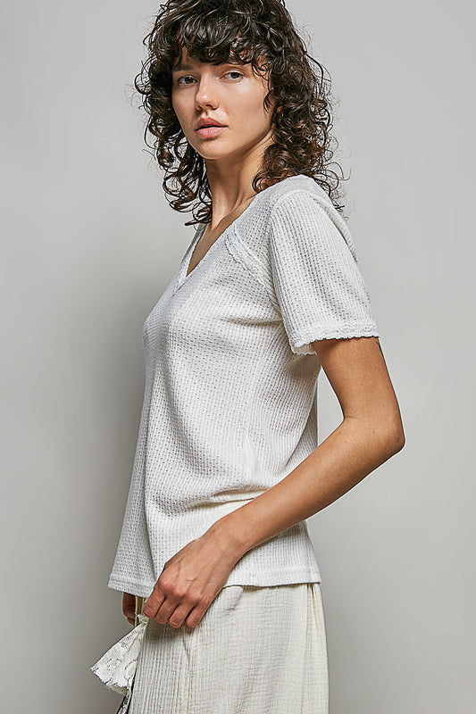 Side view of soft rayon blend t shirt with lace detailing showing slightly cropped length and breathable textured fabric construction