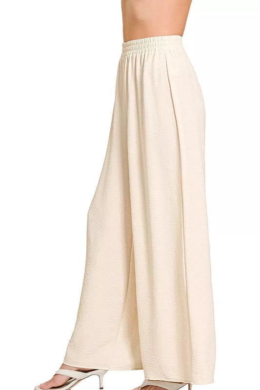 Side view of Zenana woven airflow elastic waistband pants, showing relaxed wide leg silhouette and adjustable drawstring detail at waist