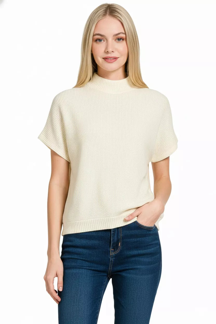 Model wearing Zenana mock neck short sleeve sweater, front angle showing knit texture.