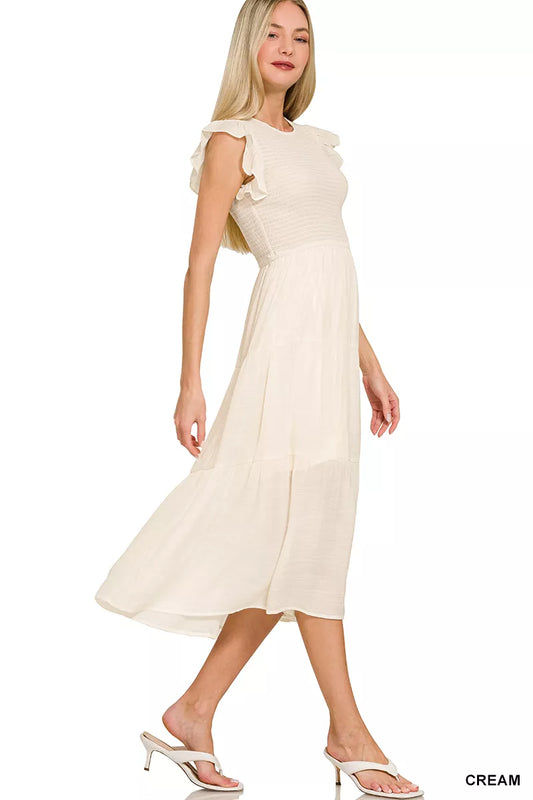 Side view of Zenana woven smocked ruffle sleeve midi dress highlighting smocked waist and fluttering ruffle sleeves