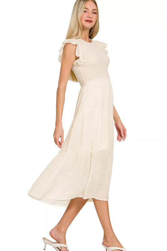Side view of Zenana woven smocked ruffle sleeve midi dress highlighting smocked waist and fluttering ruffle sleeves