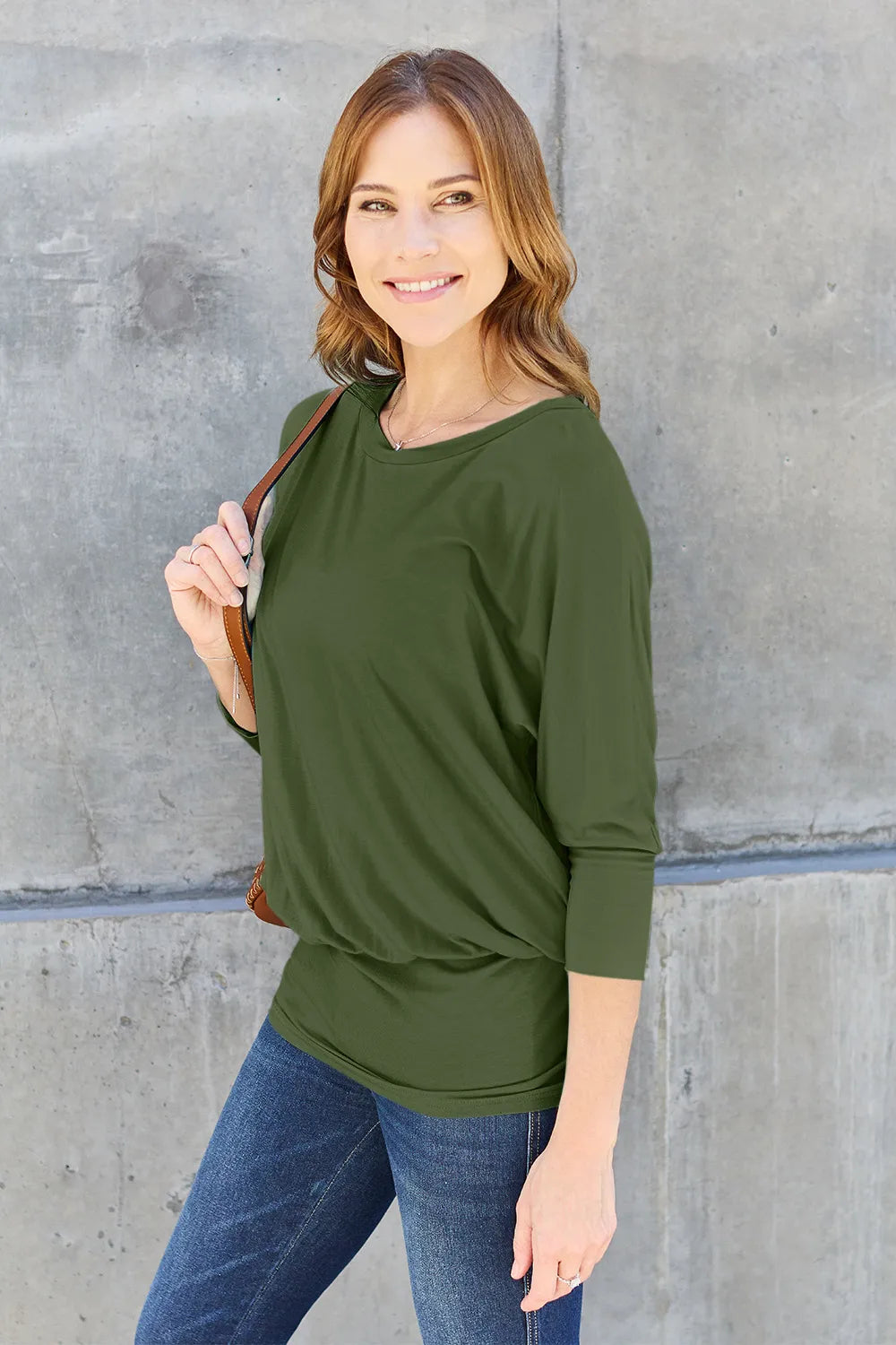 Side detail of Basic Bae full size round neck batwing sleeve top emphasizing flowing sleeves and soft fabric
