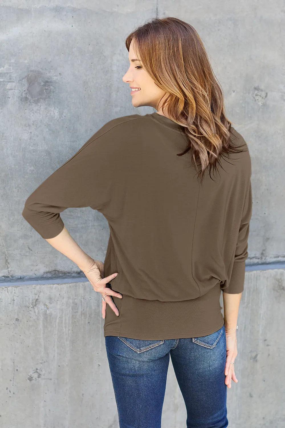 Back view of Basic Bae full size round neck batwing sleeve top showing relaxed fit and flowing sleeves
