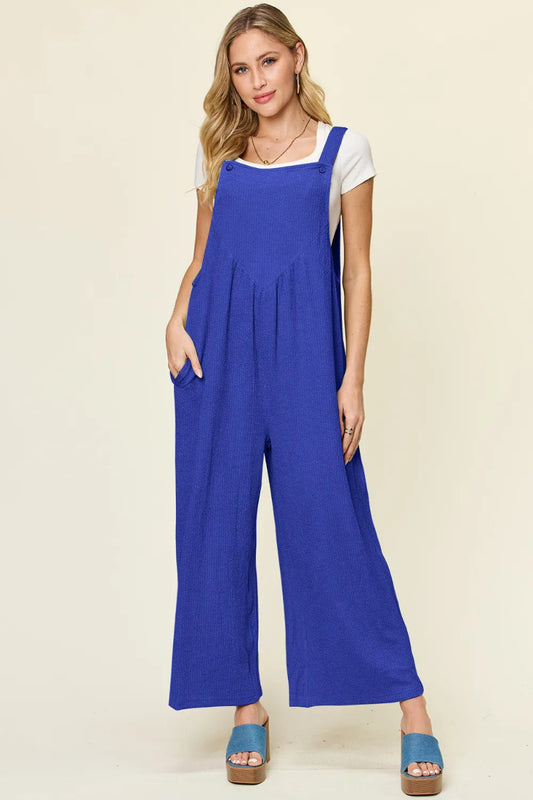 Centprime Double Take wide leg jumpsuit front view, model standing confidently in blue textured sleeveless overall showing full silhouette