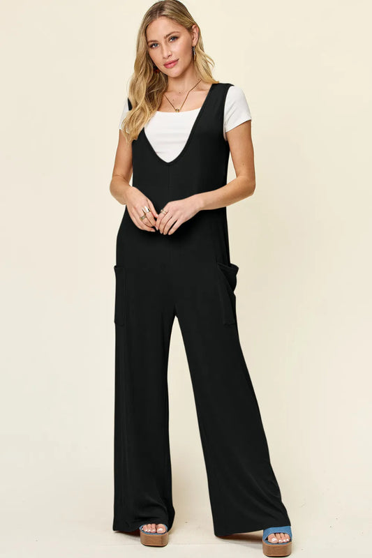 rendy sleeveless wide leg jumpsuit with pockets shown front view on model wearing size S, flowing silhouette with functional pockets visible