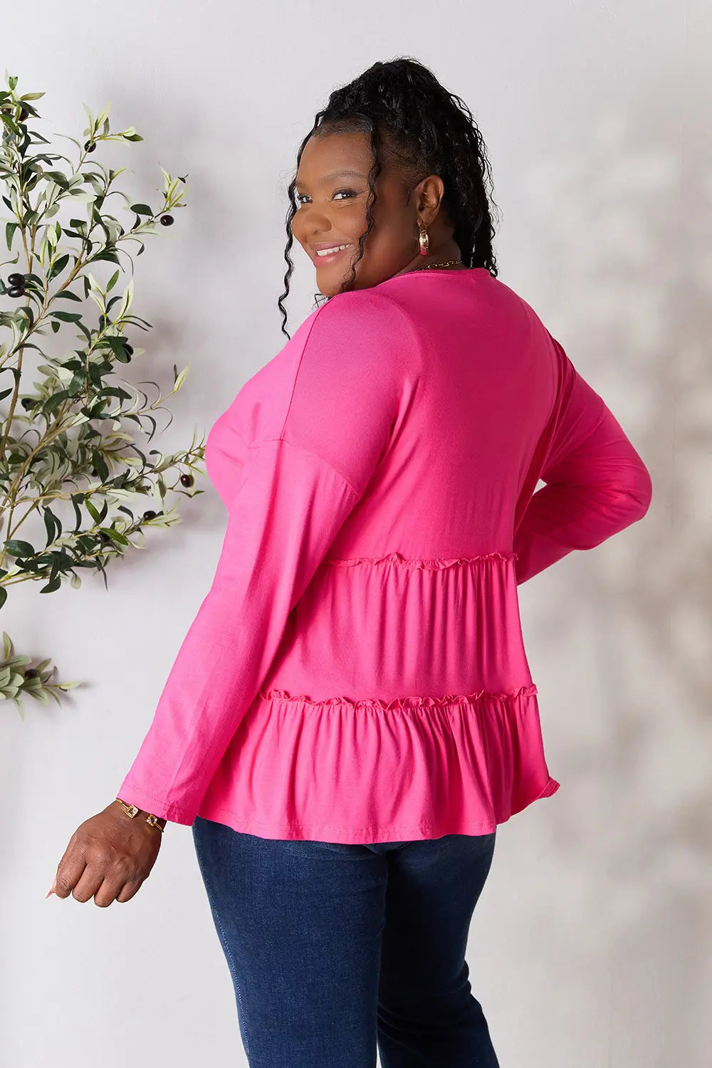 Three-quarter turned back view of Double Take half button long sleeve ruffle hem blouse.
