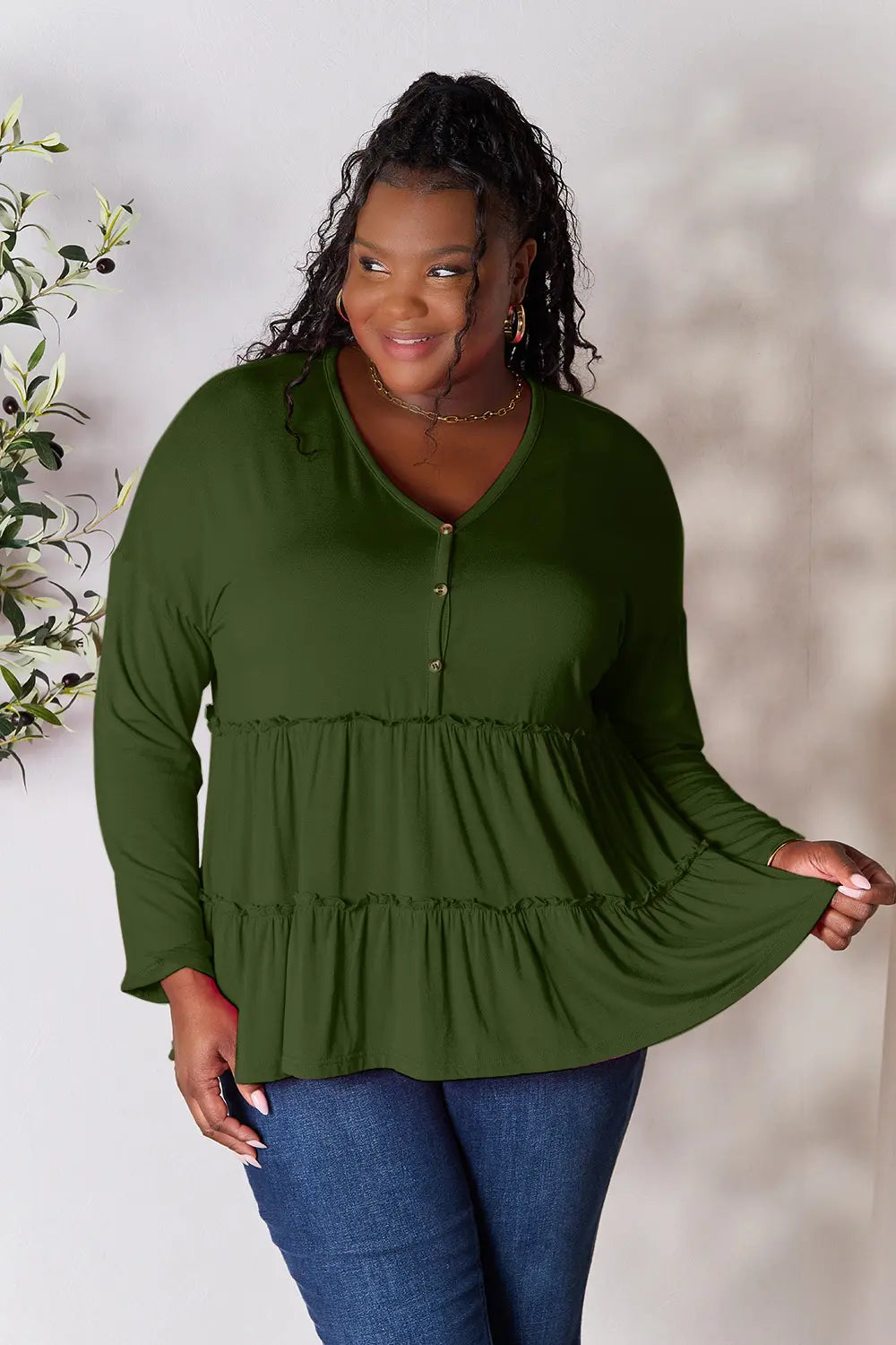 Relaxed front view of Double Take half button long sleeve ruffle hem blouse.
