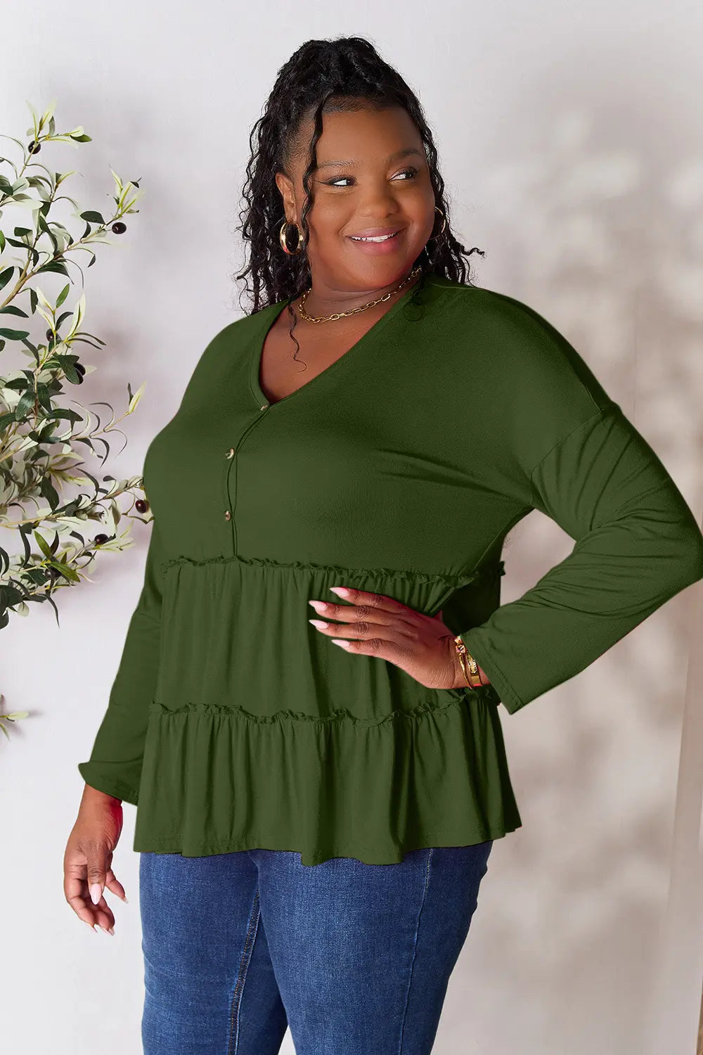 Side angle of Double Take ruffle hem blouse highlighting tiered hem.
