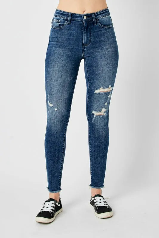 Model wearing Judy Blue full size high waist distressed skinny jeans, front angle.
