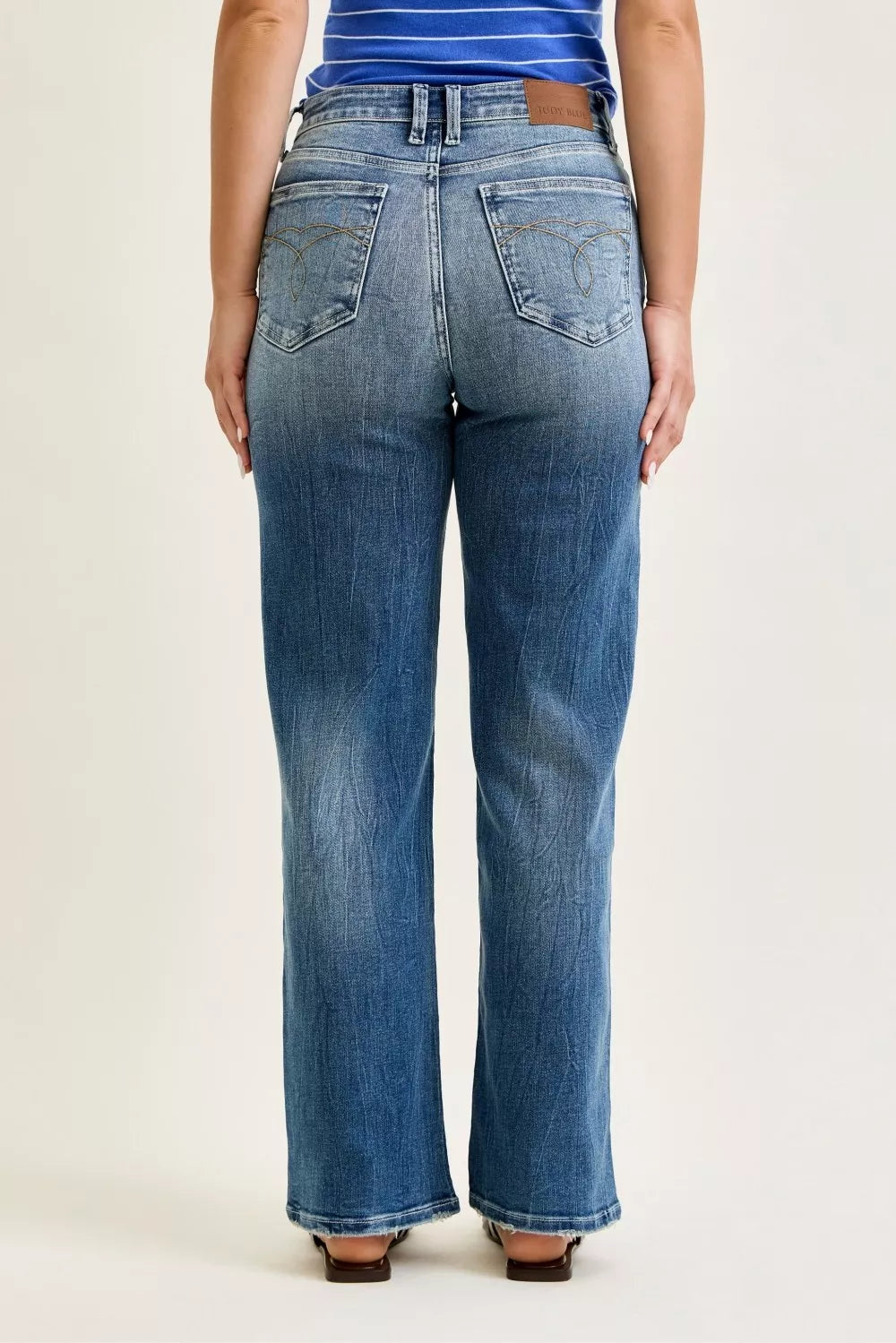 Judy Blue mid rise 90s straight leg jeans for women model standing facing back, back view of mid-rise straight leg jeans, showing back pockets and yoke detail