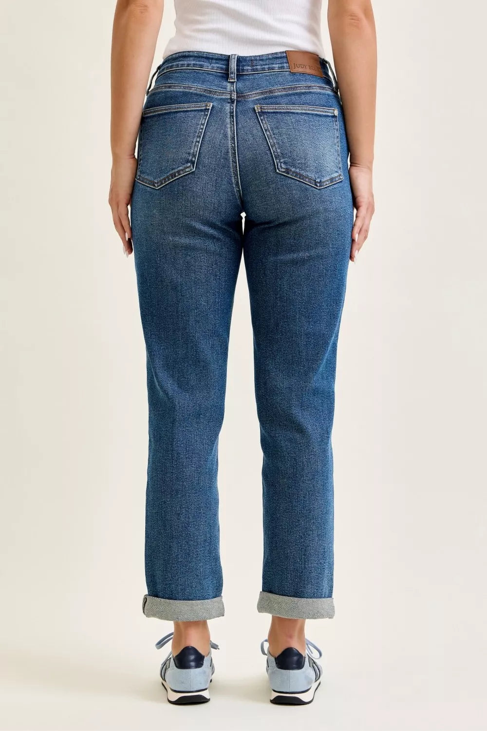 Back view of Judy Blue mid rise boyfriend embroidered repair patch jeans on model
