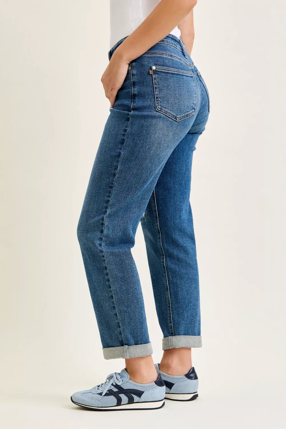 Side angle of Judy Blue mid rise boyfriend jeans highlighting embroidered repair patches
