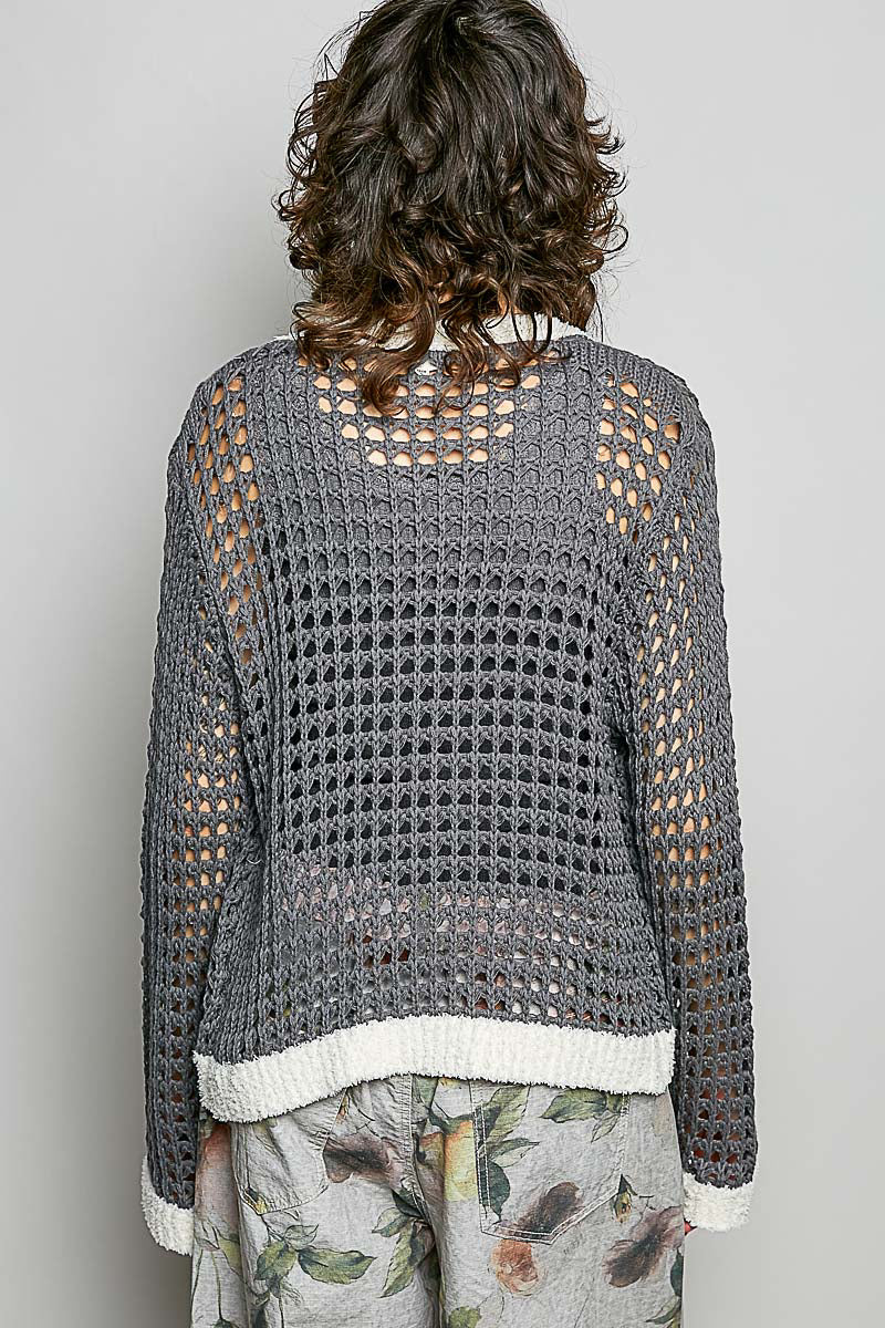 Back view of openwork contrast cardigan with regular fit, clean band hem, and floral metal button closure down the spine.
