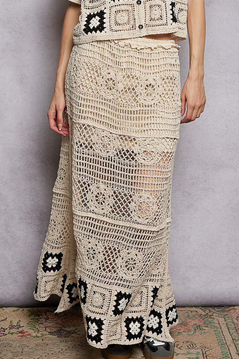 Front view of POL floral crochet maxi skirt. Boho granny square ruffled waist skirt. Handmade look floral motif crochet panels. Ruffled elastic waistband. Floor length silhouette. Open stitch weave for breathability.