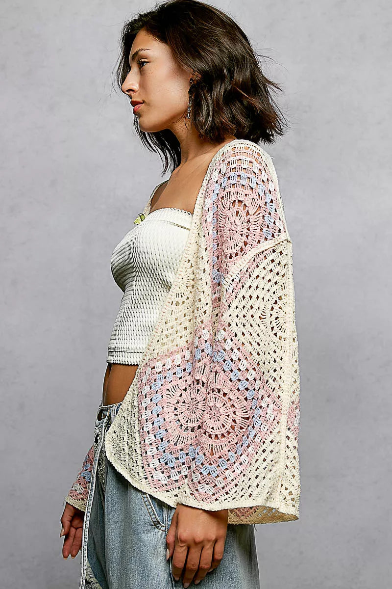 Angled side view of the POL crochet cardigan, capturing the relaxed fit and granny square pattern from both front and back.```
