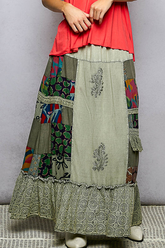 Front view of printed patchwork embroidered ruffled maxi skirt with lace ruffle hem and elastic waistband.