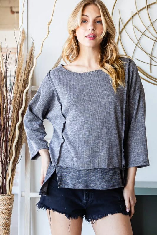 Front view of the Reborn J boat neck exposed seam slit top, showing the relaxed fit, long sleeves, and soft knit fabric.
