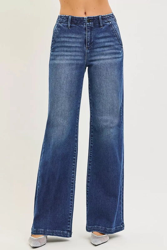 RISEN high rise wide leg slanted pocket jeans front view on a model standing straight showing high waist, slanted front pockets, and full wide leg silhouette.