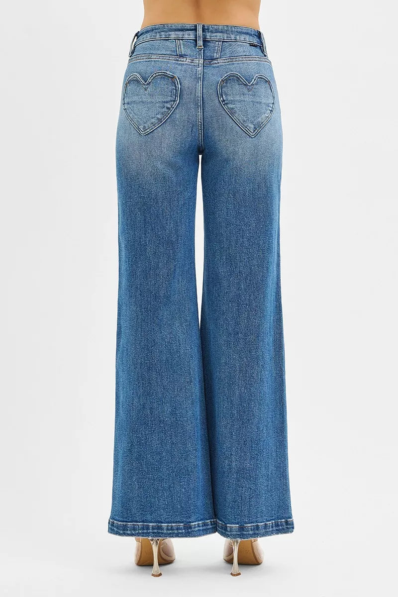Back view of RISEN high rise wide leg jeans featuring a unique heart shaped back pocket detail
