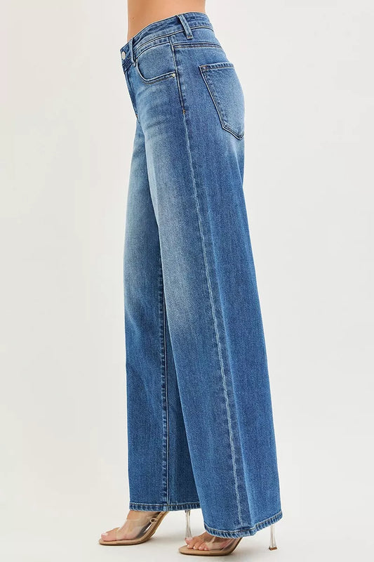 Left side profile of risen baggy jeans, relaxed leg opening, no stretch denim draping cleanly, model standing with weight evenly