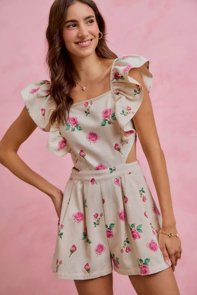 SO ME floral denim cutout ruffle romper model standing facing front, showing full romper with floral pattern, denim fabric, cutout details, and ruffle trim