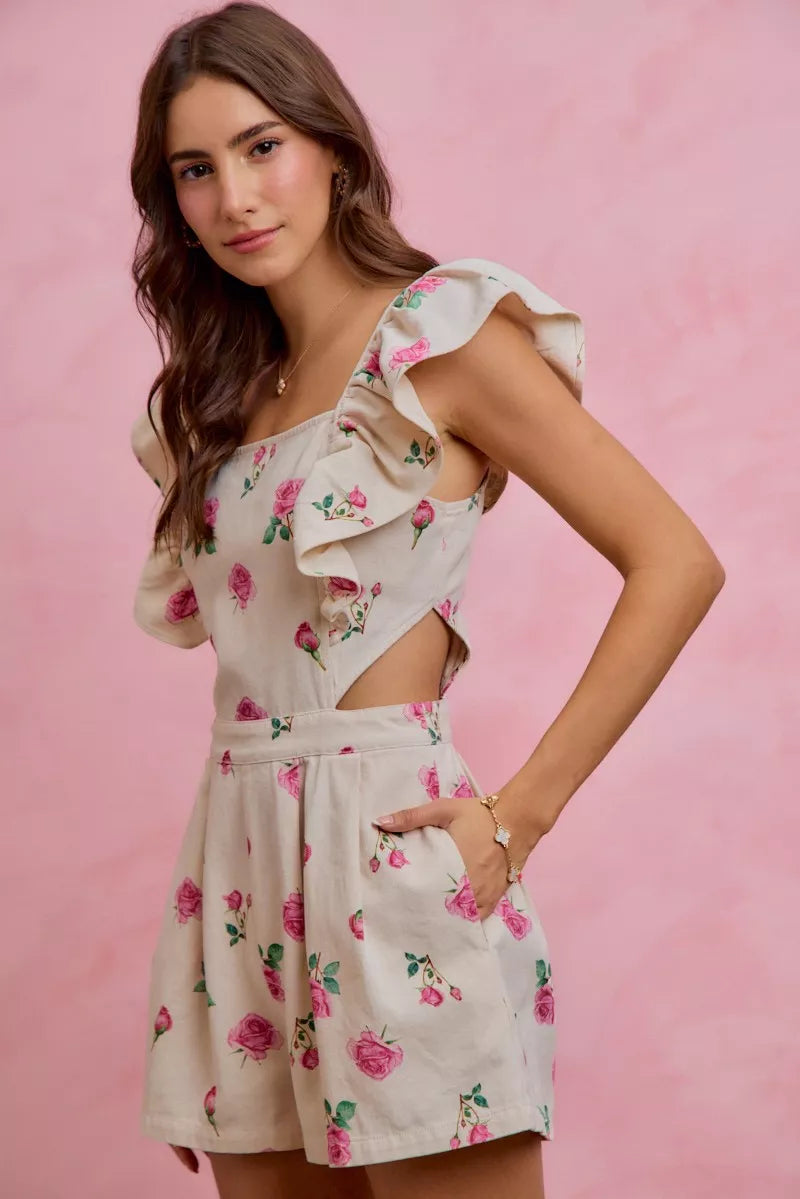SO ME floral denim cutout ruffle romper model standing facing side, side view of floral denim romper with cutouts and ruffles