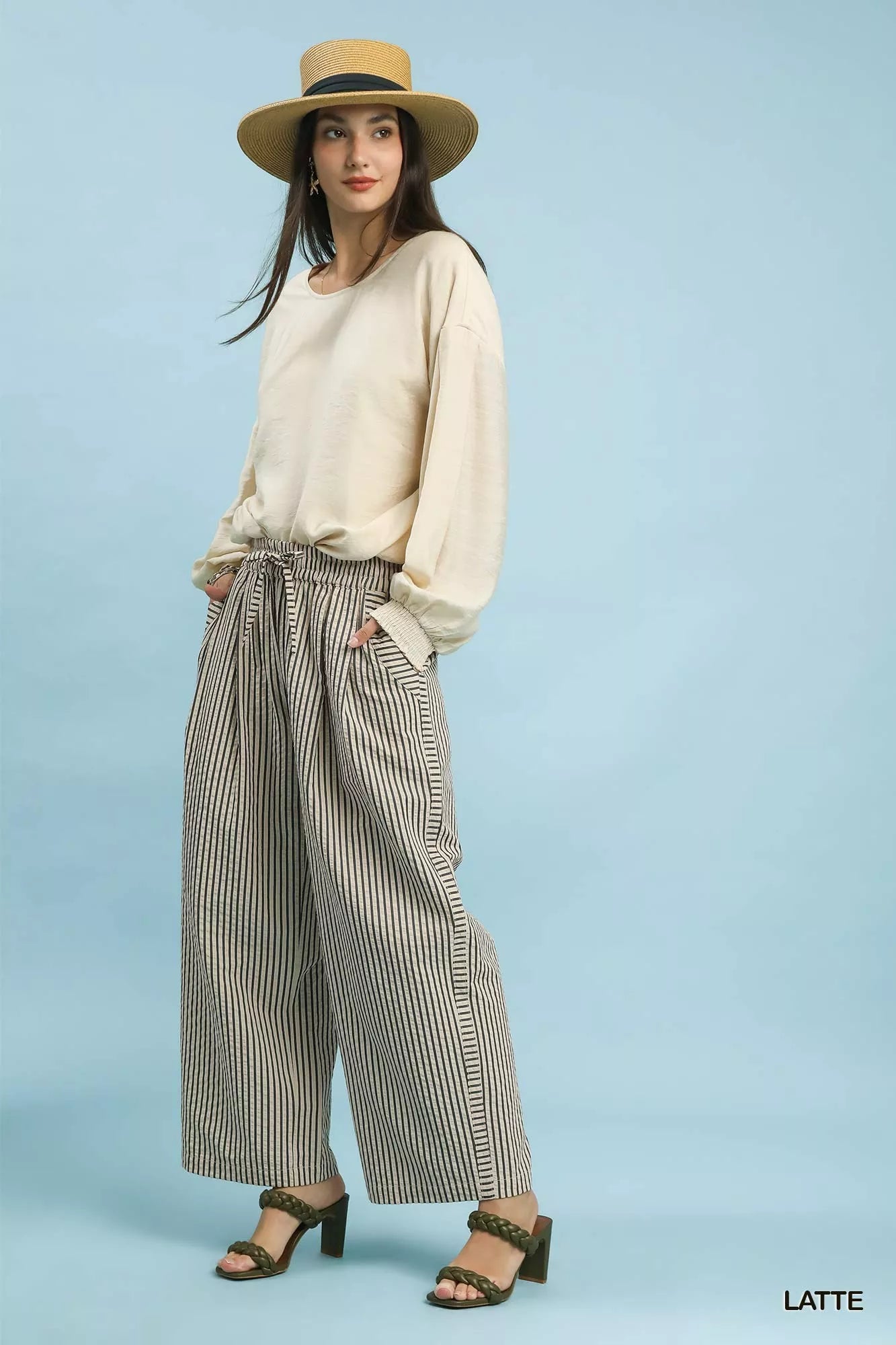 Front closeup of Umgee drawstring striped wide-leg pants, highlighting the waistband, drawstring tie, pockets, and stripe pattern.
