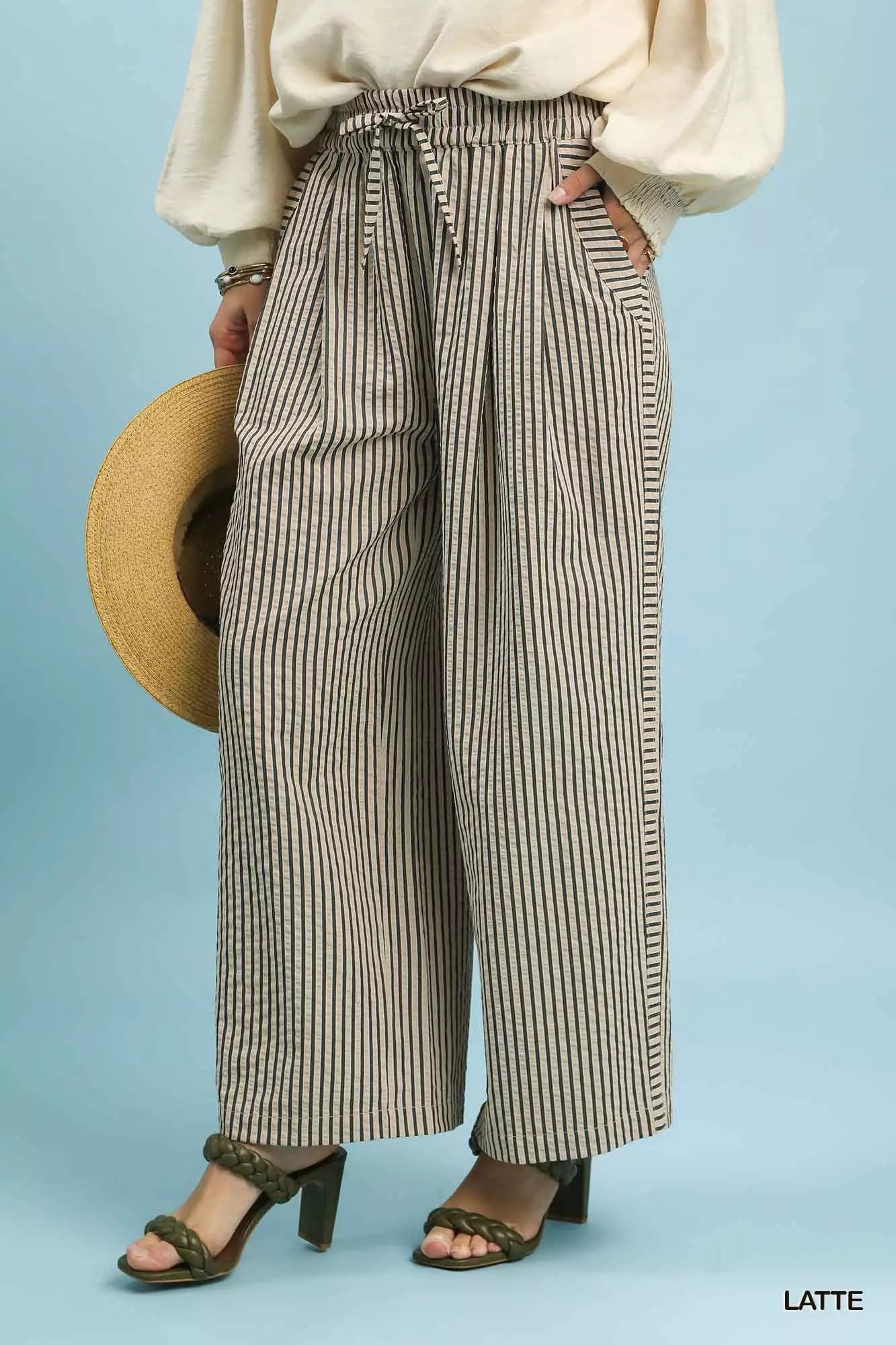 Side view of Umgee drawstring striped wide-leg pants, highlighting the drape of the wide leg and vertical stripe design.
