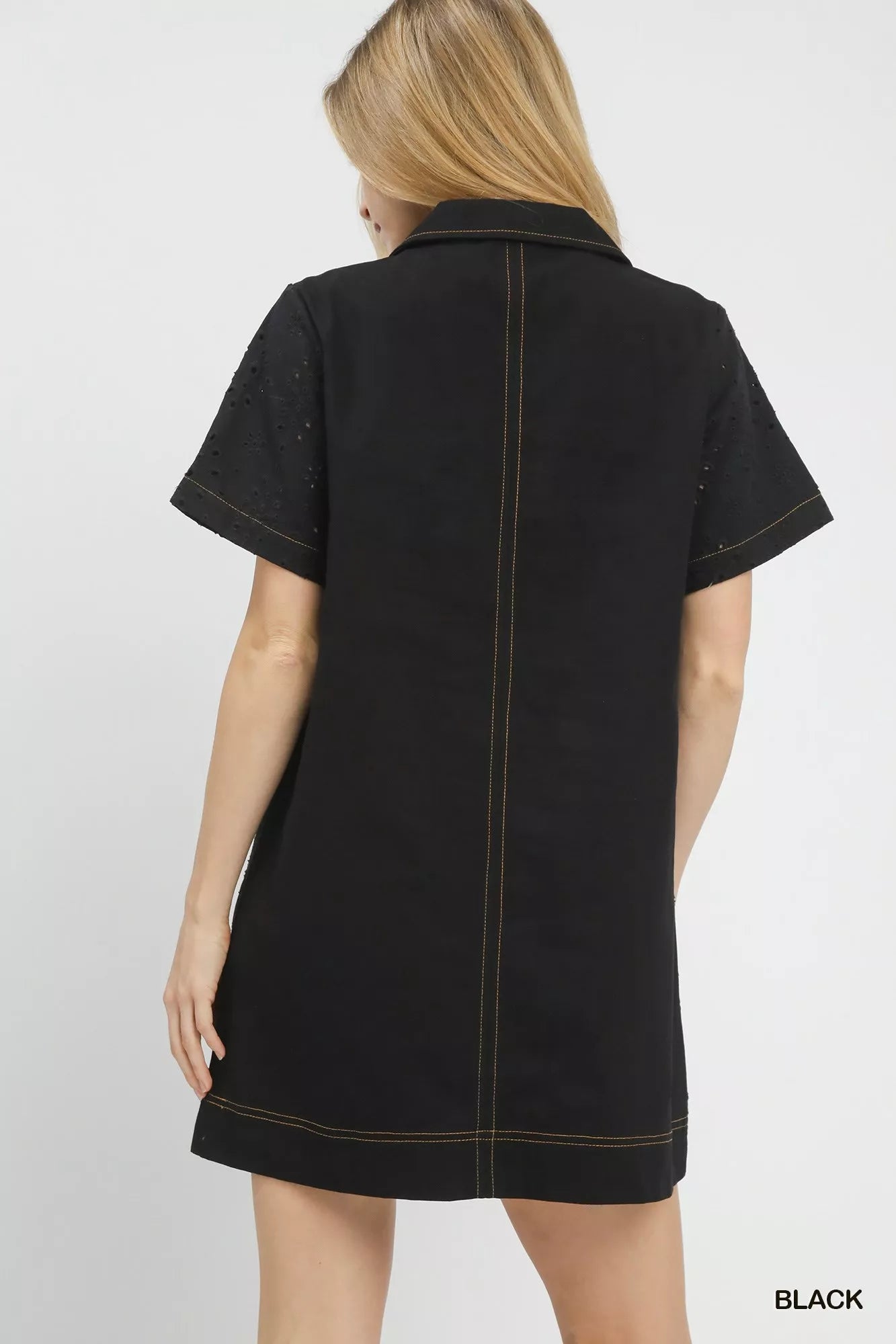 Back view of the Umgee eyelet short sleeve shift dress with pocket, showing the simple shift silhouette and eyelet texture.
