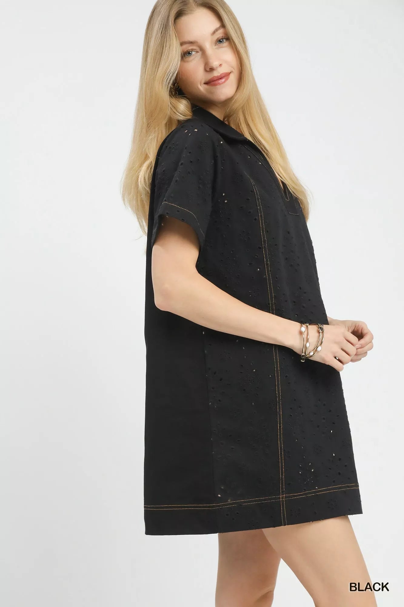 Side view of the Umgee eyelet short sleeve shift dress with pocket, highlighting the relaxed drape and short sleeve shape.
