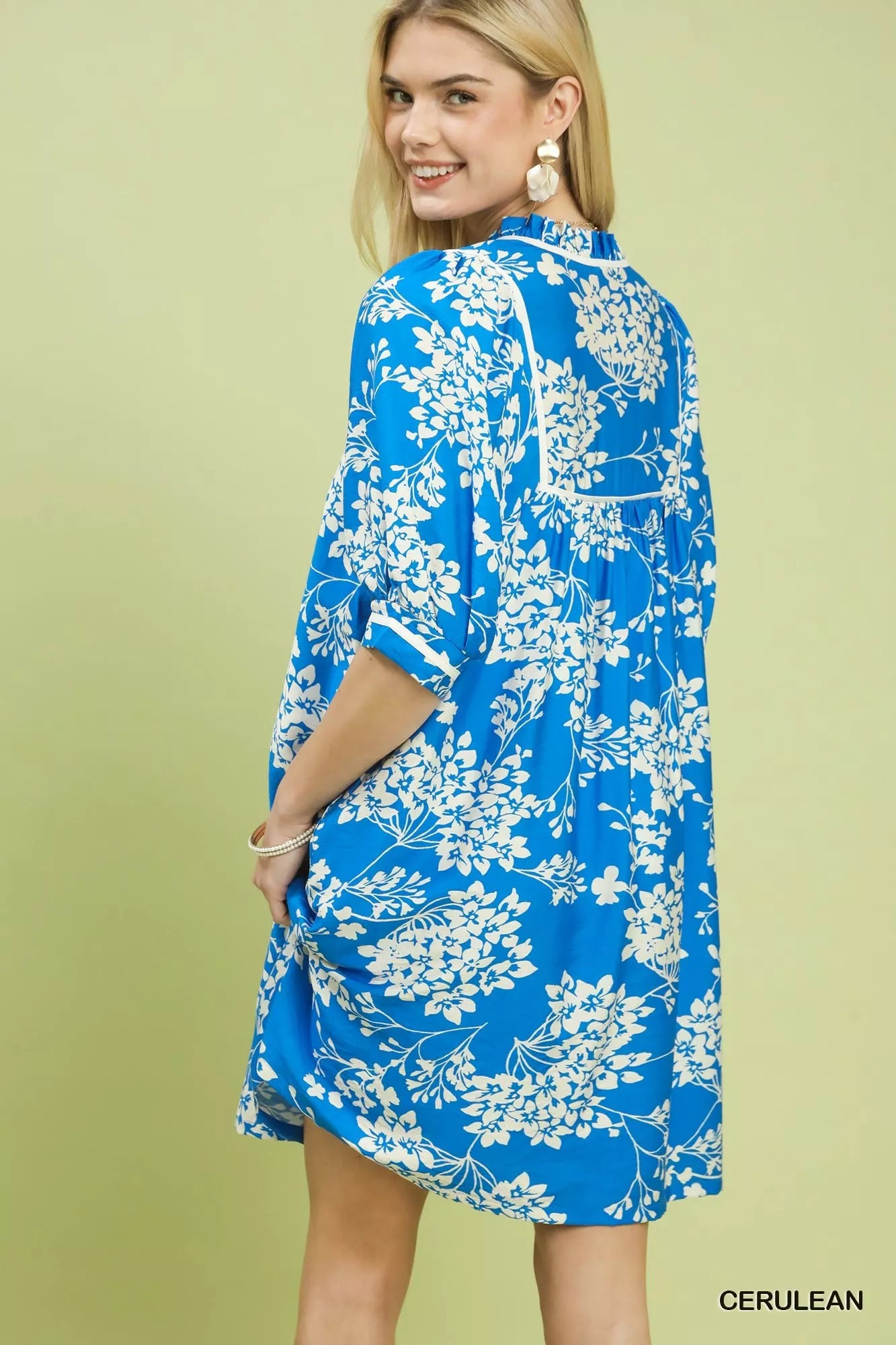 Back view of Umgee floral babydoll dress with pockets showing babydoll seam and drape
