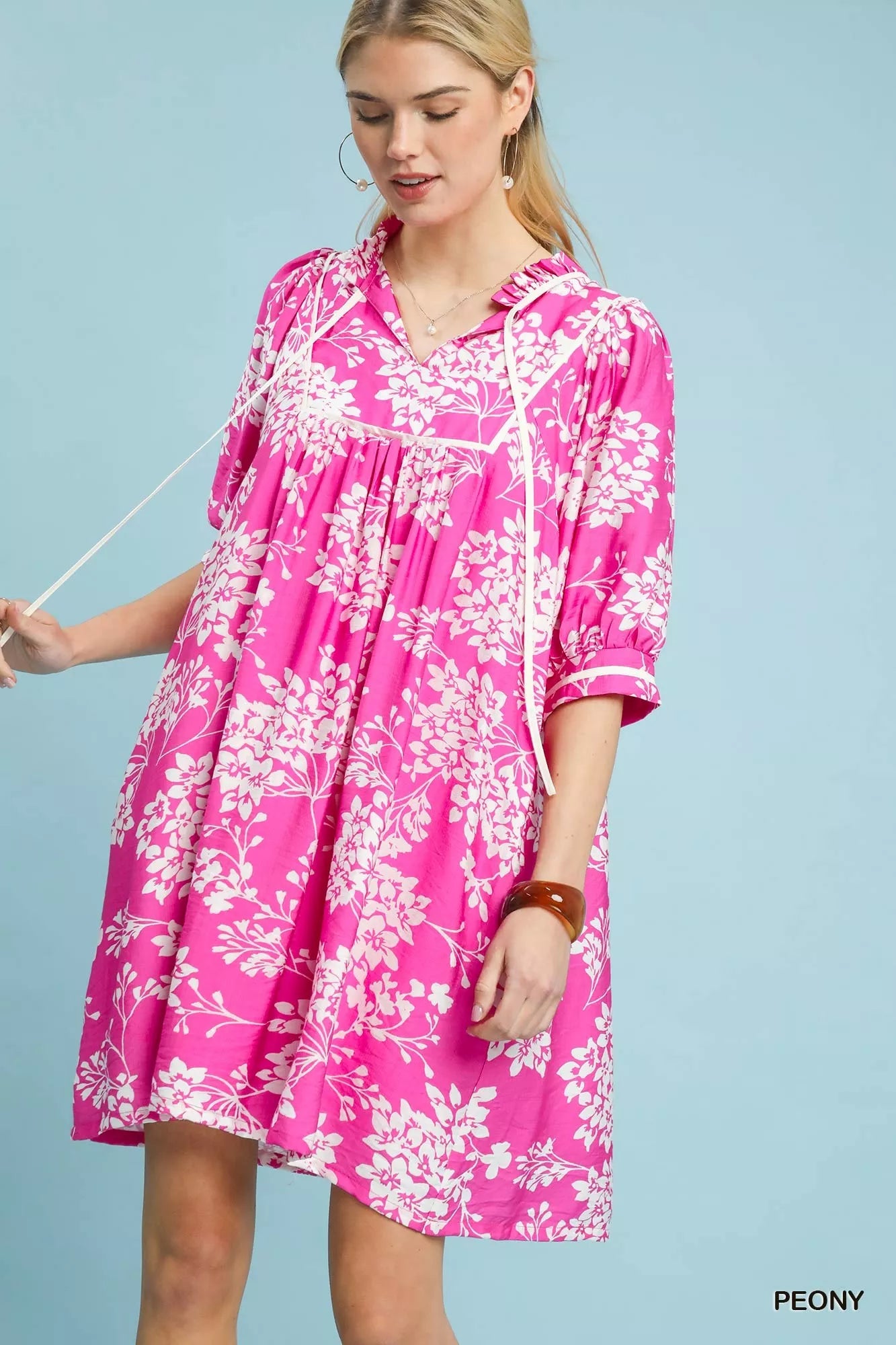 Front view of Umgee floral babydoll dress with pockets showing flowy fit and floral pattern
