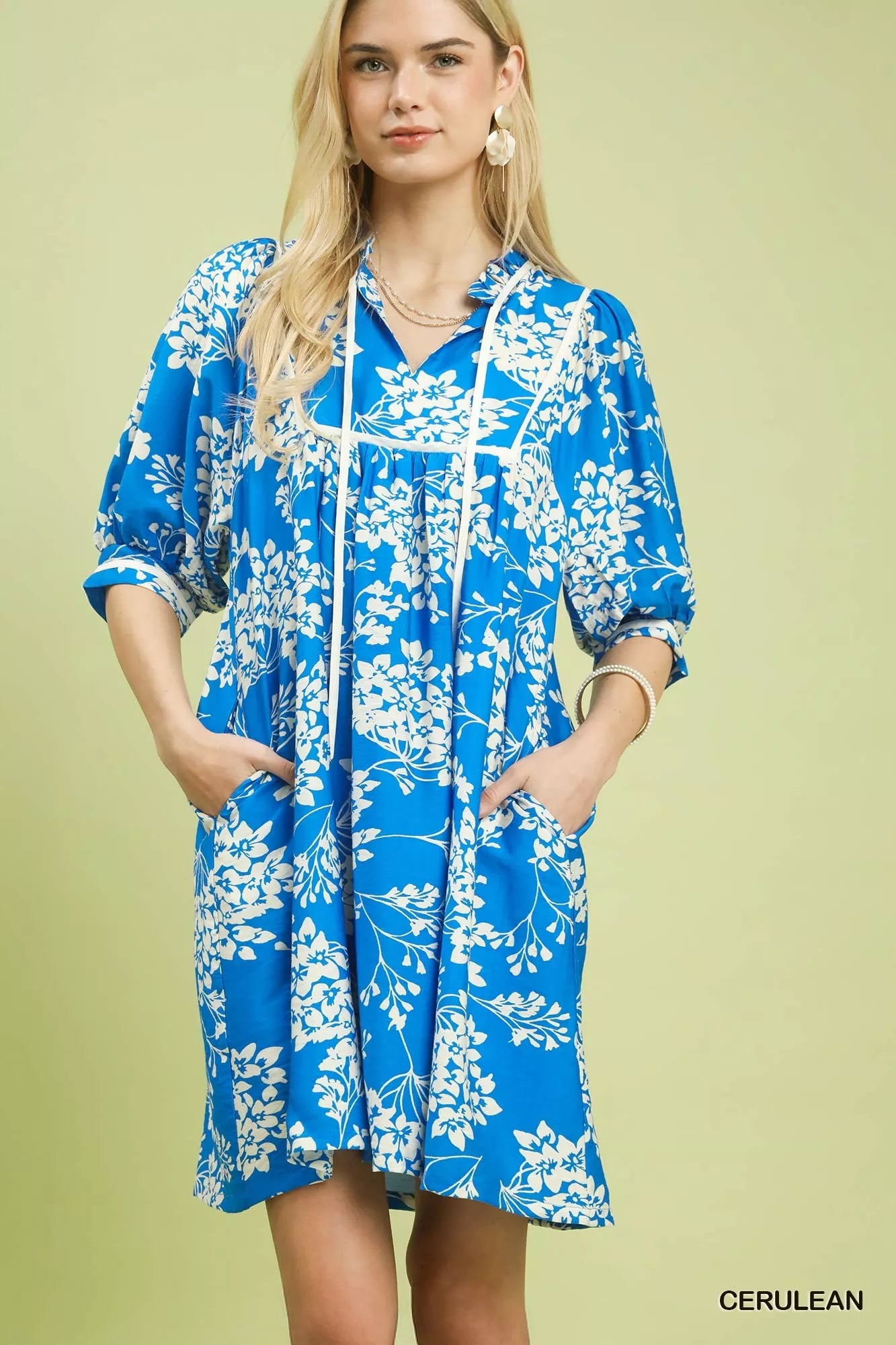 Front view of Umgee floral babydoll dress with pockets showing relaxed fit and floral print
